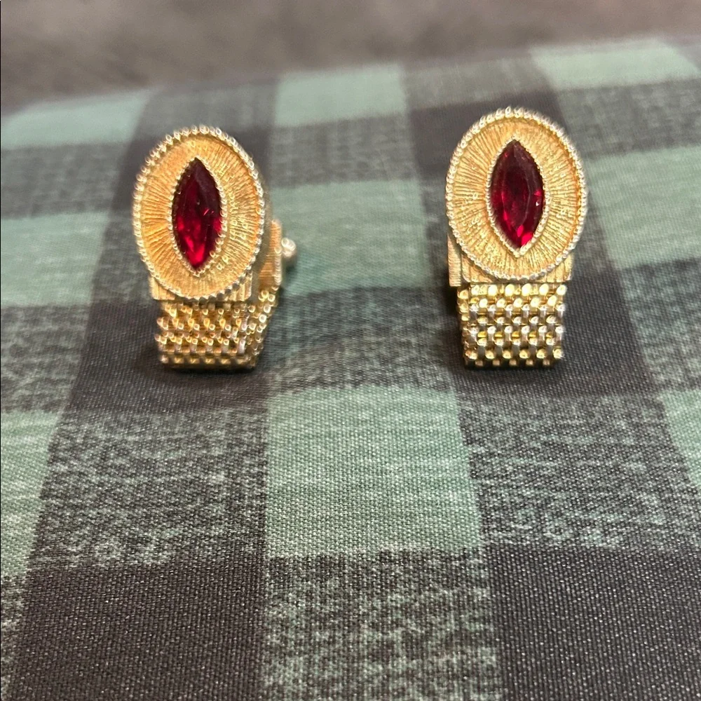 vintage gold-tone woven mesh cufflink with a red rhinestone center.